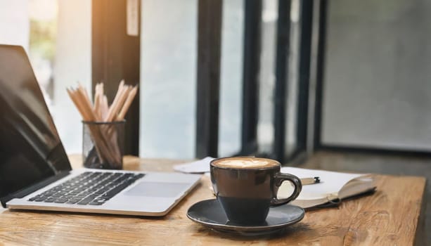 Wood office desk table with a lot of things tablet, laptop ,smartphone ,notepad and coffee cup notepad .copy space virtual interface icons screen.