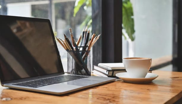 Wood office desk table with a lot of things tablet, laptop ,smartphone ,notepad and coffee cup notepad .copy space virtual interface icons screen.