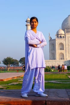 Agra, India - November 16, 2011: local tourists pose for a photo at the Taj Mahal in Agra, India. 2,5 Mio. local tourists visit the UNESCO World heritage site yearly.