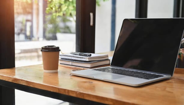 Wood office desk table with a lot of things tablet, laptop ,smartphone ,notepad and coffee cup notepad .copy space virtual interface icons screen.