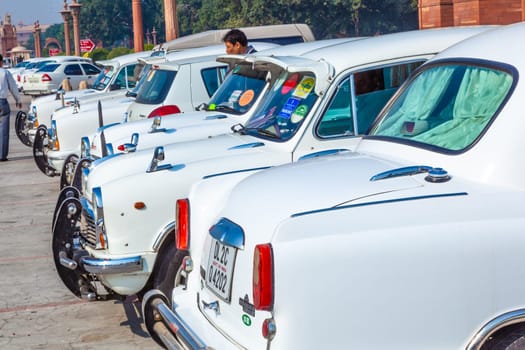 Delhi, India - November 17, 2011: AMBASSADOR car in front of indian parliament. the replica of Morris Oxforf model is still produced by HINDUSTAN MOTORS and standard for politicians.