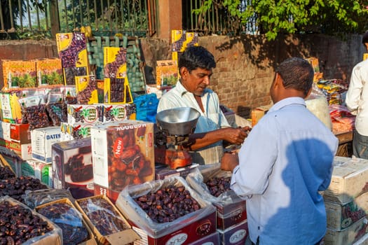 New Delhi, India - November 17, 2011: people at Meena Bazaar in Chandni Chowk area selling goods at the old open air market in India.