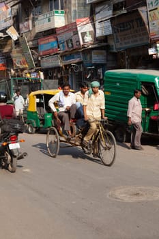 New Delhi, India - November 17, 2011: streetlife at oldest market Chandni Chowk in old Delhi. People carrying goods, sell goods and carrying goods  at Meena Bazaar in Chandni Chowk