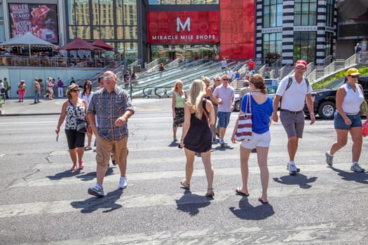 Las Vegas, USA - June 16, 2012: people hurry to cross the street the Strip in Las Vegas, USA. They cross the street at a pedestrian crossing.