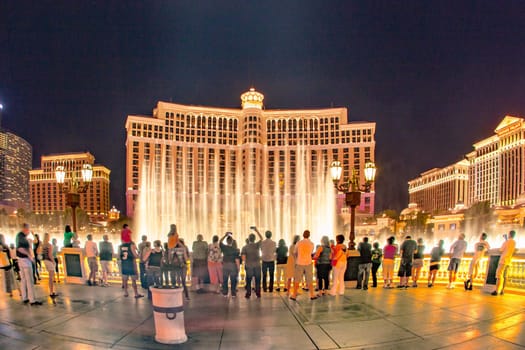 Las Vegas, USA - June 15, 2012: people watch the famous fountain show at Las Vegas Bellagio Hotel Casino at night on June 15, 2012 in Las Vegas, Nevada.
