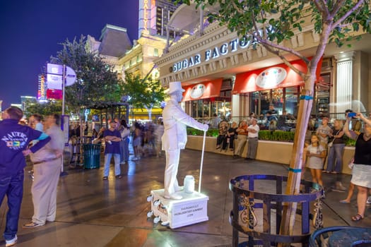 Las Vegas, USA - June 15, 2012: advertising for diamond cut and world entertainment at the Strip by night by a white movable statue.
