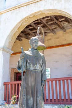 Santa Barbara, USA - June 23, 2012: View of a statue and bell in Santa Barbara California dedicated to Spanish missionary Junipero Serra