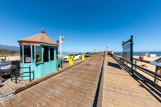 Santa Barbara, USA - June 23, 2012: scenic view to historic wooden pier in Santa Barbara, USA with green painted entrance booth for cars.