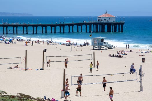 Redondo Beach, USA - June 24, 2012:  people enjoy the  beautiful beach in Redondo beach  with volleyball courts and old wooden pier, Los Angeles, USA