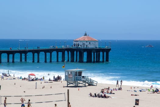 Redondo Beach, USA - June 24, 2012:  people enjoy the  beautiful beach in Redondo beach  with volleyball courts and old wooden pier, Los Angeles, USA