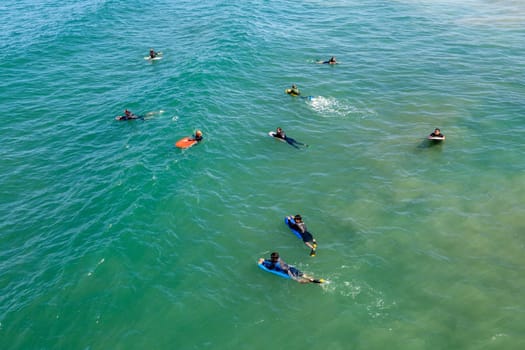 Los Angeles, USA - June 25, 2012: people at Redondo beach wait in the ocean for the next wave for surfing.
