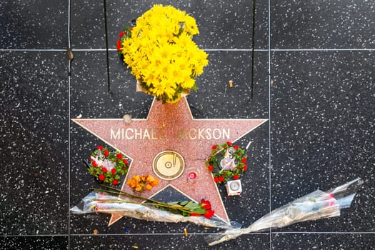 Los Angeles, USA - June 26, 2012: yellow flowers, red roses and other flowers at the star for Michael Jackson at the walk of fame.