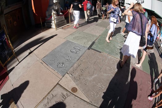 Los Angeles, USA - June 24, 2012: handprints of stars in Hollywood in the concrete of Chinese Theatre's forecourts.  There are nearly 200 celebrity handprints in the concrete of the forecourt.