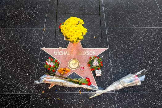 Los Angeles, USA - June 26, 2012: yellow flowers, red roses and other flowers at the star for Michael Jackson at the walk of fame.