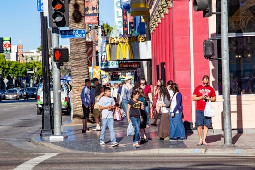 Los Angeles, USA - June 24, 2012: people promenade at the Hollywood boulevard at the walk of fame with thousands of stars from famous Hollywood legends.