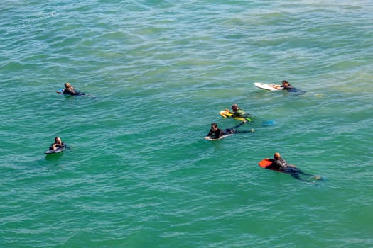 Los Angeles, USA - June 25, 2012: people at Redondo beach wait in the ocean for the next wave for surfing.
