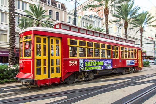 New Orleans, USA - July 17, 2013:  people travel with the famous old Street car St. Charles line in New Orleans, USA.  It is the oldest continually operating street car line in the world.