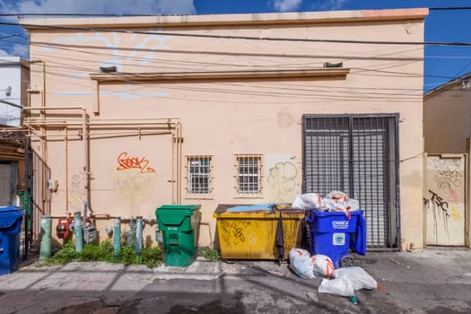 Mimi Beach, USA - August 5, 2013: small street with old buildings in the art deco district with litter box in Miami, USA.