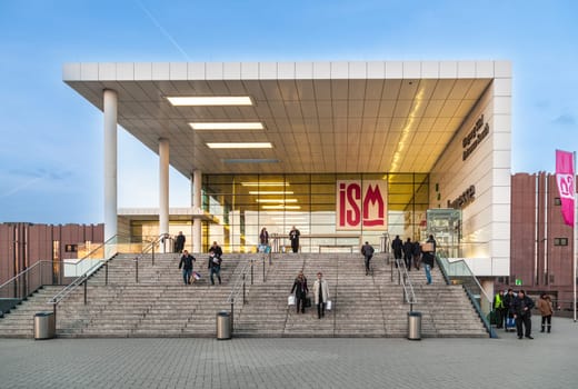 Cologne, Germany - January 29, 2014: : people at entrance of the ISM in Cologne, Germany. ISM Cologne is the biggest confectionery trade fair which deals with various kinds of sweets and biscuits.