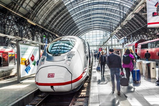 Frankfurt, Germany - May 16, 2014: Inside the Frankfurt central station in Frankfurt, Germany. People hurry to the intercity high speed train.