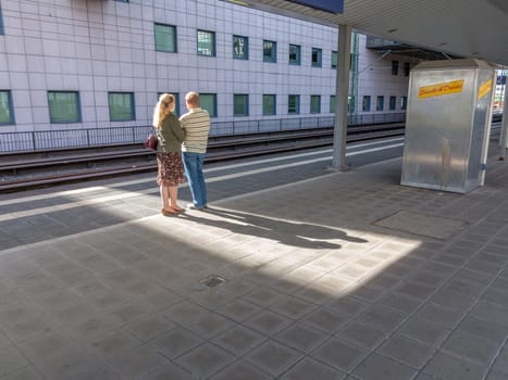 Frankfurt, Germany - May 17, 2014: couple  waits for next s- Bahn - local Train - at station Messe - engl: fair.