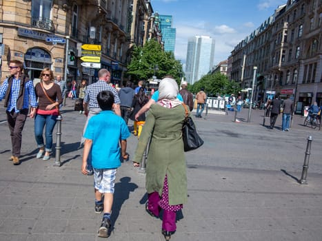 Frankfurt, Germany - May 16, 2014: foreign people, mother and son, at the foreground of Frankfurt central train station.