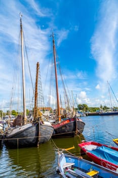 Harlingen, Netherlands - August 18, 2014: pier with old boats in Harlingen, Netherlands. Harlingen became town in 1234 and is also called Venice of Netherlands.