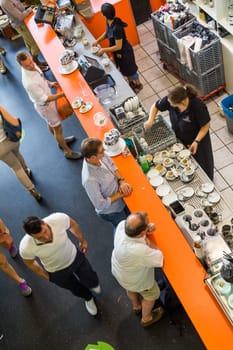 Frankfurt, Germany - August 9, 2014: people enjoy having a cafe in the Kleinmarkthalle in Frankfurt, Germany. The hall from 1954 is the most famous fresh food market in Frankfurt on 1500 SQ (m2).