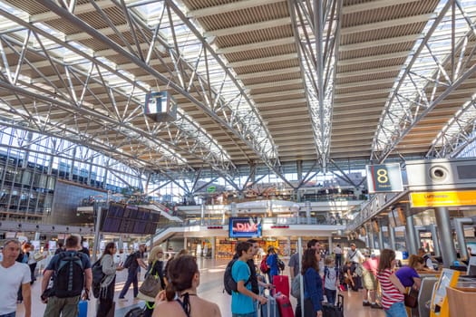 Hamburg, Germany - July 17, 2014: people at the check in and baggage drop area in modern Hamburg airport.