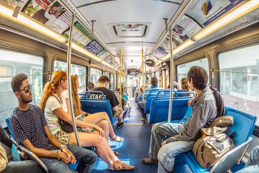 MIAMI, USA - AUG 18, 2014: people in the downtown Metro bus in Miami, USA. Metrobus operates more than 90 routes with close to 1,000 buses covering 41 million miles per year.