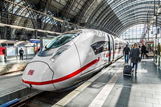 Frankfurt, Germany - May 16, 2014: Inside the Frankfurt central station in Frankfurt, Germany. People hurry to the intercity high speed train.