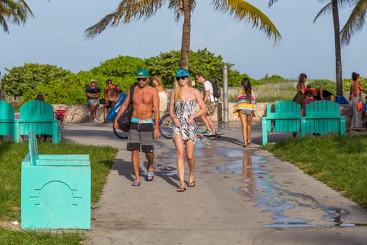 Miami, USA - August 18, 2014: People at the sea side park ar Ocean street in Miami, USA. Miami Beach is a popular destination among tourists, spiking during the winter time.