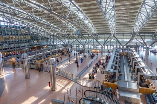 Hamburg, Germany - July 17, 2014: people at the check in and baggage drop area in modern Hamburg airport.