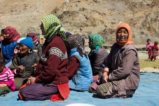 Leh, India - September 18, 2014: portrait of villagers sitting in traditional costumes at the meeting place near Leh in province Ladakh in India.