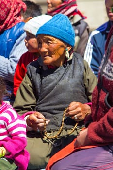 Leh, India - September 18, 2014: portrait of sitting local woman in traditional costume near Leh in province Ladakh in India.