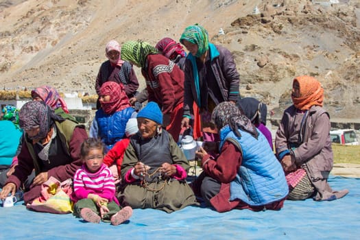 Leh, India - September 18, 2014: portrait of villagers sitting in traditional costumes at the meeting place near Leh in province Ladakh in India.