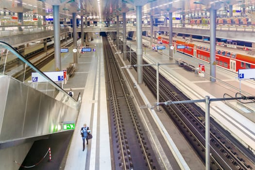 BERLIN, GERMANY - NOV 27, 2014: People inside the Berlin Central train station in Berlin, Germany. It is the is the main railway station in Berlin with a surface area of 85x120 mt.