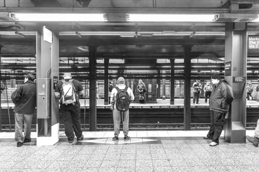 New York, USA - October 20, 2015: People wait at subway station Wall street in New York. With 1.75 billion annual ridership, NYC Subway is the 7th busiest metro system in the world.
