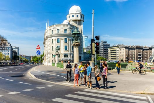 Vienna, Austria - April 25, 2015: people at famous Urania in Vienna. Urania is a public educational institute and observatory  built according to the plans of Art Nouveau style architect Max Fabiani in 1910.