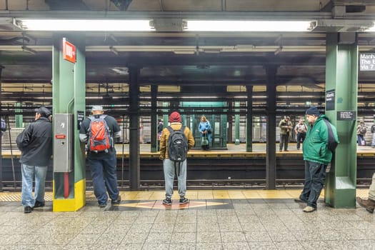 New York, USA - October 20, 2015: People wait at subway station Wall street in New York. With 1.75 billion annual ridership, NYC Subway is the 7th busiest metro system in the world.
