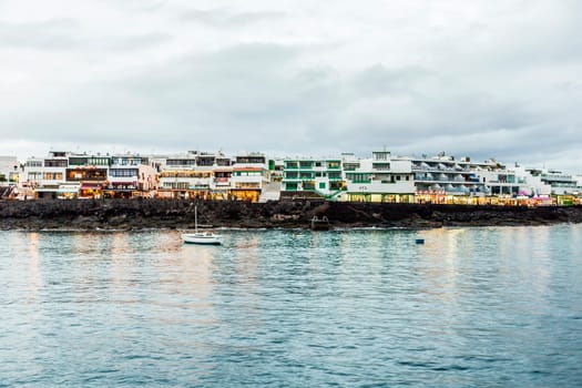 Playa Blanca, Spain - November  19, 2014: scenic seaview of promenade by night of Playa Blanca, Spain. Playa Blanca became a tourist village since 1980 when a lot of hotels and appartmens were built.