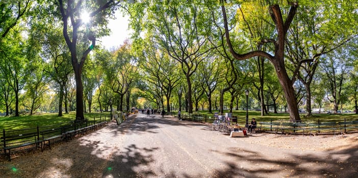 NEW YORK, USA - OCT 21, 2015: People enjoying walking in  Central Park. The park is the most visited urban park in the United States with 35 million visitors annually.