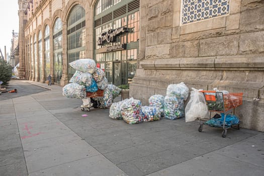 New York, USA - October 4, 2017: poor people collect cans and plastic bottles and sell them back to shops. They earn money by getting a small deposit on the cans.