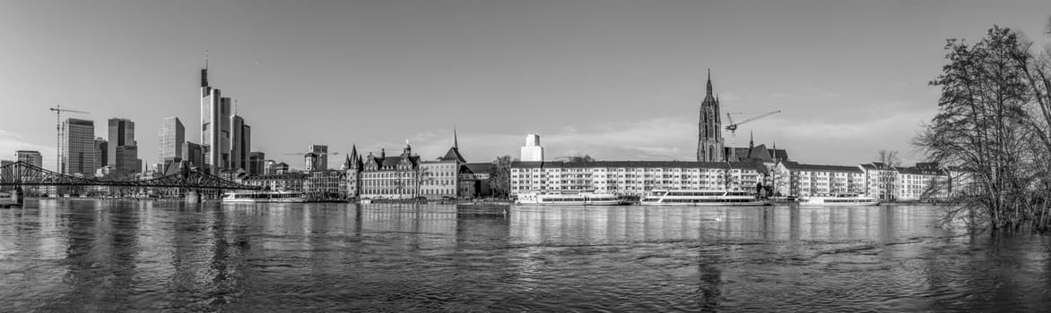 Frankfurt, Germany - January 9, 2018: panoramic view to skyline of Frankfurt am Main, Germany with high water at river Main.