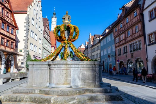 Rothenburg ob der Tauber, Germany - April 6, 2018: colorful easter decoration at a fountain in Rothenburg ob der Tauber.