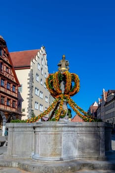 Rothenburg ob der Tauber, Germany - April 6, 2018: colorful easter decoration at a fountain in Rothenburg ob der Tauber.
