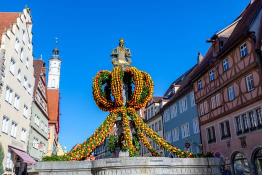 Rothenburg ob der Tauber, Germany - April 6, 2018: colorful easter decoration at a fountain in Rothenburg ob der Tauber.