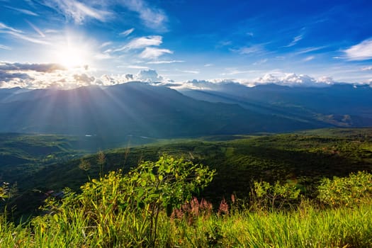 Sunset view from the most known El Camino Real trail in Barichara, Colombia. The trail is surrounded by lush greenery and offers stunning views of the surrounding hills of Andes mountains.