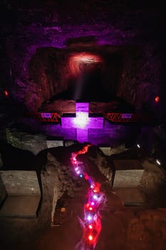Illuminated cross representing stations of the cross, illustrate events of Jesus last journey, light in underground Catedral de Sal (Salt Cathedral) of Zipaquira, one of Colombian wonders, Colombia.