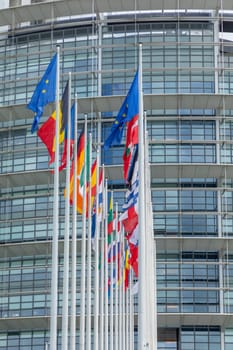 STRASBOURG, FRANCE - JUNE 18, 2018: All EU Flags European Union flag waving in front of European Parliament, headquarter of the European Commission European Parliament